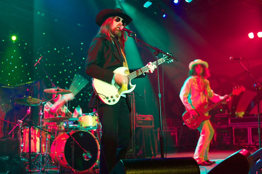 Leroy Powell performing with his band on a stage lit green and red